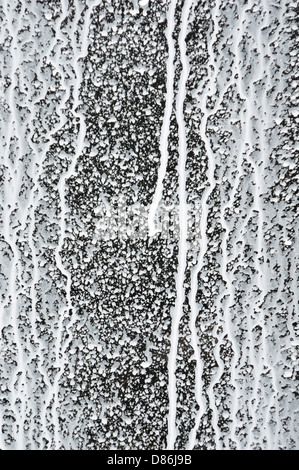 Abstract paint splash. Messy white paint drips on black background. Stock Photo