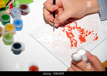 Child's hand painting with watercolors. Stock Photo