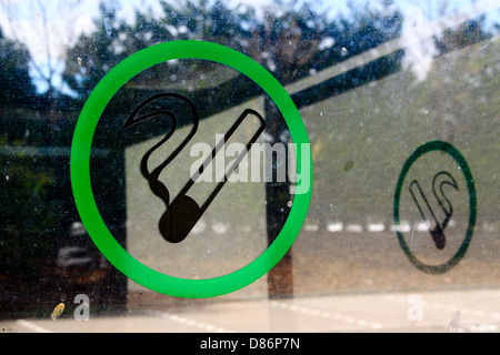 Sign on window of designated smoking area Stock Photo