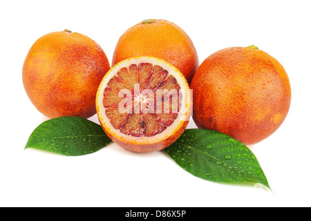Ripe red blood oranges with cut and green leaves isolated on white background. Closeup. Stock Photo