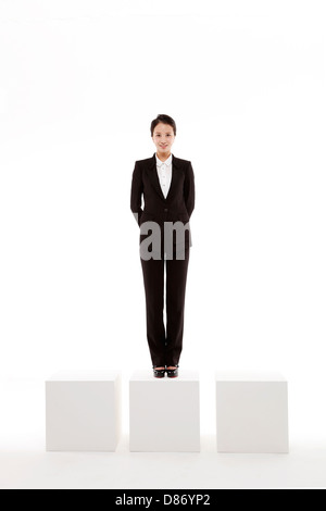 young businesswoman standing on box. Stock Photo