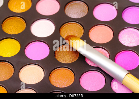 Set of multicolored eyeshadows with makeup brush Stock Photo