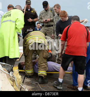 Moore, Oklahoma, USA. 20th May 2013. Destroyed buildings and overturned cars are seen after a huge tornado struck Moore.  A huge tornado with winds of up to 200 miles per hour (320 kph) devastated the Oklahoma City suburb of Moore on Monday, ripping up at least two elementary schools and a hospital and leaving a wake of tangled wreckage. At least 91 people were killed, KFOR television said, citing a reporter's eyewitness account, and hospitals said dozens of people were injured Credit:  ZUMA Press, Inc. / Alamy Live News Stock Photo