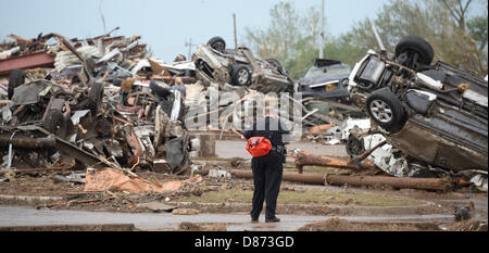 Moore, Oklahoma, USA. 20th May 2013. Destroyed buildings and overturned cars are seen after a huge tornado struck Moore.  A huge tornado with winds of up to 200 miles per hour (320 kph) devastated the Oklahoma City suburb of Moore on Monday, ripping up at least two elementary schools and a hospital and leaving a wake of tangled wreckage. At least 91 people were killed, KFOR television said, citing a reporter's eyewitness account, and hospitals said dozens of people were injured Credit:  ZUMA Press, Inc. / Alamy Live News Stock Photo