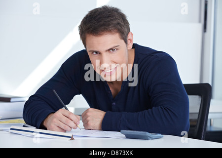 Architectural draftsman working at his desk in the office on a blueprint Stock Photo