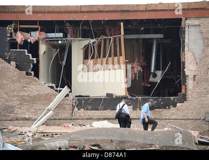 Moore, Oklahoma, USA. 20th May 2013.Destroyed buildings and overturned cars are seen after a huge tornado struck Moore.  A huge tornado with winds of up to 200 miles per hour (320 kph) devastated the Oklahoma City suburb of Moore on Monday, ripping up at least two elementary schools and a hospital and leaving a wake of tangled wreckage. At least 91people were killed, KFOR television said, citing a reporter's eyewitness account, and hospitals said dozens of people were injured Credit:  ZUMA Press, Inc. / Alamy Live News Stock Photo