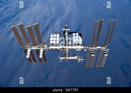 Image showing the International Space Station (ISS) in orbit above Earth with visible solar arrays and modules Stock Photo