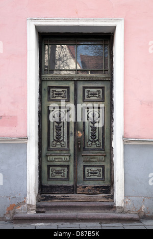 Green wooden door with decoration in old building facade. Tallinn, Estonia Stock Photo