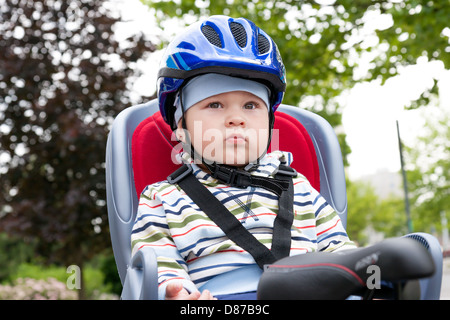 little boy with blue helmet on bicycle Stock Photo