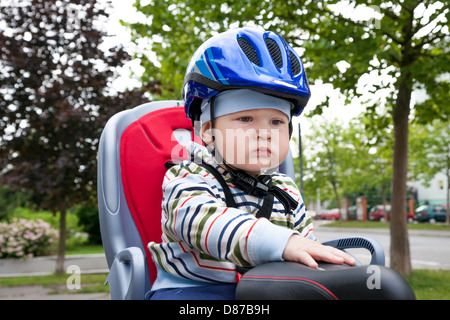 little boy with blue helmet on bicycle Stock Photo