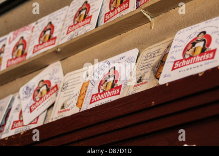 Exposure of Schultheiss' beer mats at 'Tiergartenquelle' pub in the Tiergarten's area of Berlin, Germany Stock Photo