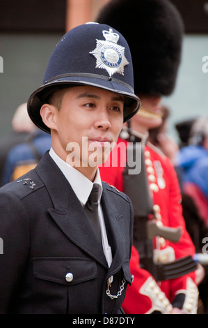 Young Asian police officer on duty in London Stock Photo