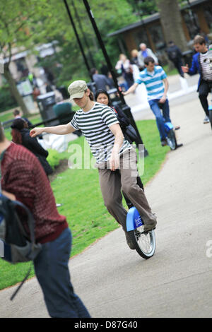 London, UK. 21st May 2013. An organizer encourages passers by to get involved with the free Jackpotjoy unicycle scheme held in London, Russel Square, 21st May 2013. Credit:  Graeme George / Alamy Live News Stock Photo
