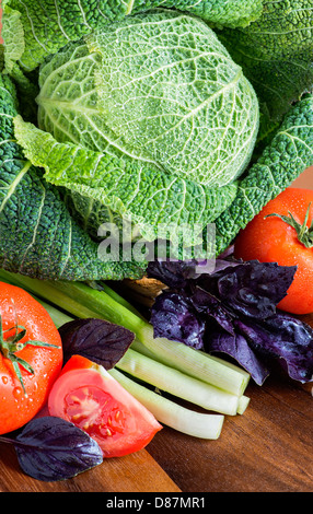 Vegetables and herbs on a wooden table, selective focus Stock Photo