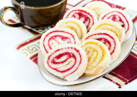 Strawberry and lemon jam swiss roll with cup of coffee, selective focus Stock Photo