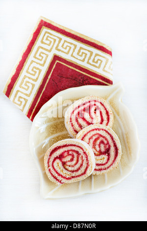 Strawberry and lemon jam swiss roll on plate over light background Stock Photo