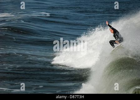 Surfer landing a dramatic aerial cutback on a wave at Jacksonville Beach, Florida. USA. Stock Photo