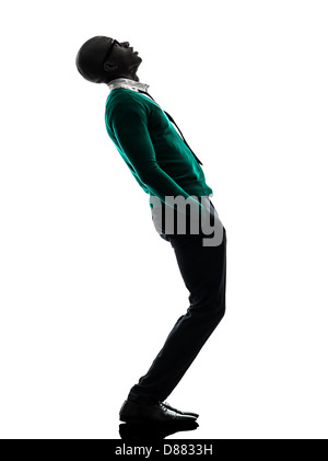 one african black man standing looking up surprised in silhouette studio on white background Stock Photo