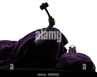 one person smashing alarm clock in bed waking up smashing alarm clock silhouette studio on white background Stock Photo