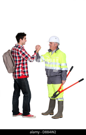 Experienced tradesman meeting his new apprentice Stock Photo