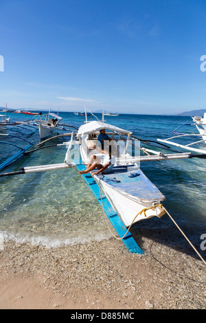 Typical Ferry Boat on the Big La Laguna Beach on Mindoro Island, Philippines Stock Photo