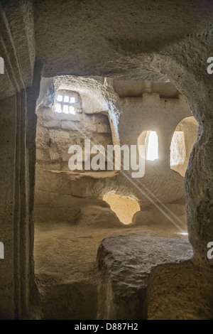 Early Christian church carved out of solid rock in Cappadocia, Central Anatolia, Turkey with shafts of sunlight Stock Photo