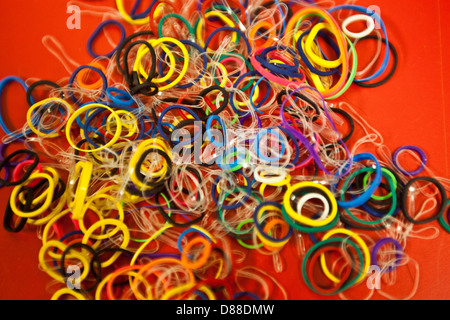 Rubber Bands on Red Background Stock Photo