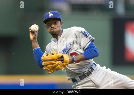 Los Angeles Dodgers' Dee Gordon holds on to his helmet as he