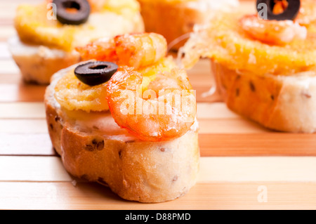 Shrimp bruschetta with fried cheese. Shoot in low key technique Stock Photo