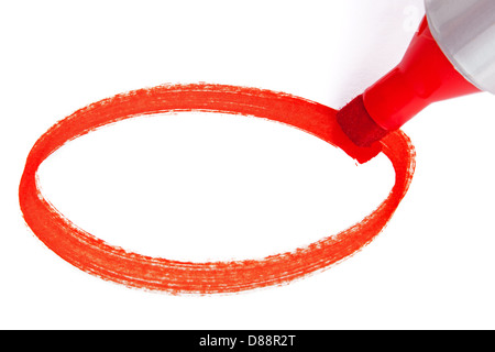 Close-up photo of a big red felt tip marker pen writing an empty circle on white paper Stock Photo