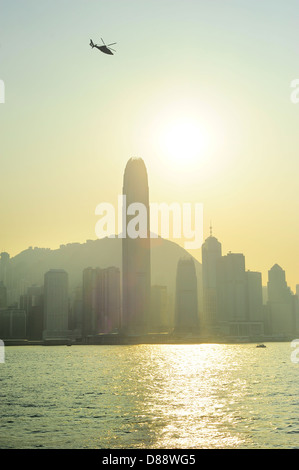 Helicopter in Hong Kong sky at sunset Stock Photo