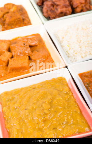 Thali - Indian meal set with vegetarian and meat curries, pilau rice and onion bhajis. Stock Photo