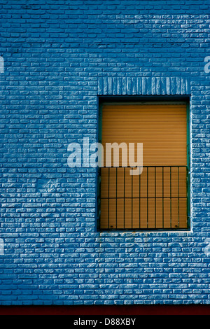 old yellow window in light blue wall in the centre of la boca buenos aires argentina Stock Photo