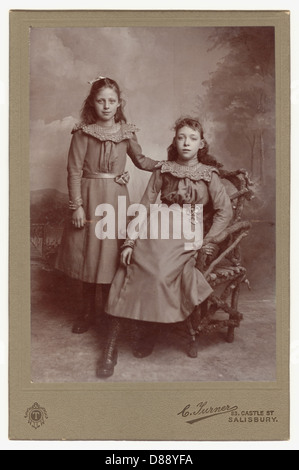 Original cabinet card photograph portrait of two pretty young Victorian or Edwardian era girls, probably sisters - circa 1899 Salisbury, Wiltshire, England, U.K. Stock Photo