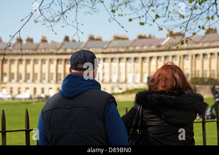 couple looking across at the Royal Crescent, at Bath, Somerset UK in April - built between 1767 and 1775 and designed by John Wood the Younger Stock Photo