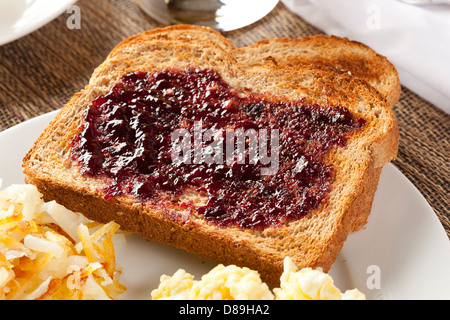 Homemade Wholesome American Breakfast with eggs, toast, and hashbrowns Stock Photo