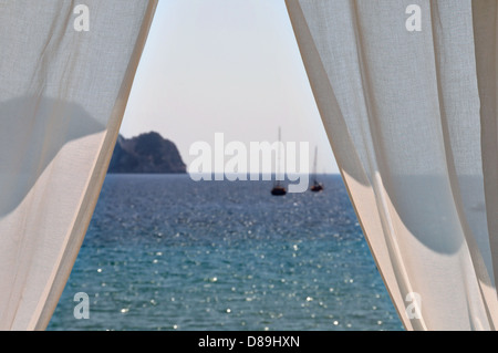 White curtains window view to sea and boats. Summer abstraction, focus on the drapes. Stock Photo