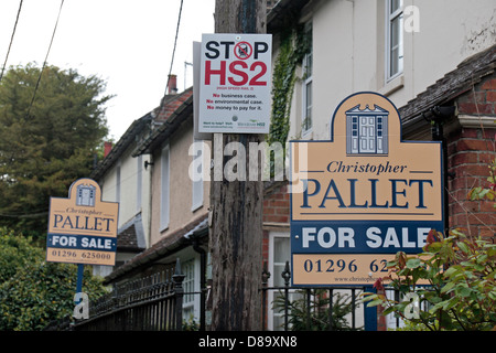 A 'Stop HS2' poster on a telephone pole close to two house 'for sale' signs, in Wendover, Buckinghamshire, UK. (May 2013) Stock Photo