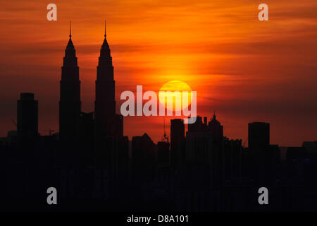 May 22, 2013 - Kuala Lumpur, Malaysia - The sun sets near Malaysia's iconic Petronas Twin Towers (L) in Kuala Lumpur. Malaysia attracted RM49.3 billion investments in the first quarter of 2013, a 44 per cent jump compared to the same period in 2012, said the Malaysian Investment Development Authority  (Credit Image: © Najjua Zulkefli/ZUMAPRESS.com) Stock Photo