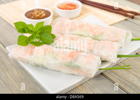 Goi Cuon - Vietnamese fresh summer rolls filled with prawns, pork, herbs, rice vermicelli and vegetables. Stock Photo