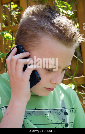 Young Boy talking on a mobile phone Stock Photo