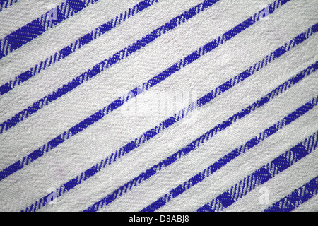 This fabric texture features diagonal stripes in blue on a white background. The design creates a clean, visually striking appearance, ideal for various fabric applications. Stock Photo