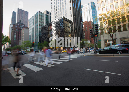 downtown chicago loop michigan avenue shops shopping center shoppers crossing street on magnificent mile with high end shops Stock Photo