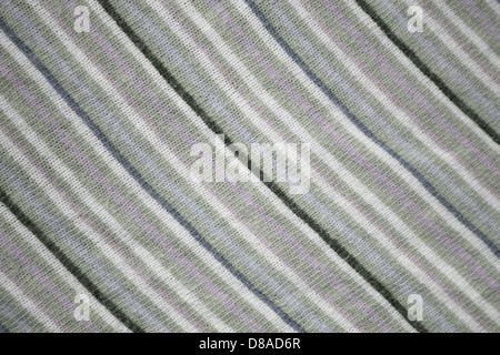 This close-up image showcases a diagonally striped knit fabric in sage green and heather colors. The texture and pattern of the knit are clearly visible, ideal for use in textiles and fashion. Stock Photo