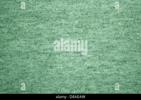 A close-up of green heather knit fabric, showcasing its textured pattern. The fabric is soft, with interwoven fibers creating a heathered appearance, making it suitable for casual wear like T-shirts. Stock Photo