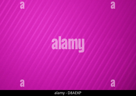 This image showcases a plastic surface with hot pink diagonal stripes. The bright pink color contrasts sharply with the alternating stripes, creating an eye-catching and bold pattern. The texture is smooth and glossy, providing a modern and energetic feel suitable for design applications. Stock Photo