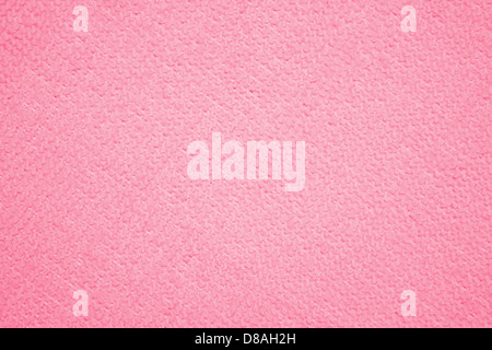 This close-up shows the soft and smooth texture of a salmon pink coral microfiber cloth. The fabric features a fine, plush feel, commonly used in cleaning and furniture upholstery due to its absorbent and gentle qualities. The light color adds a subtle and modern touch, perfect for household or commercial use. Stock Photo