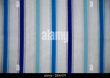 This image displays a textured striped fabric, with alternating blue and white lines. The simple yet striking pattern can be used in various textile designs or fashion contexts, offering a clean and fresh aesthetic. Stock Photo