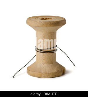 Old wooden spool with leftover threads isolated on white Stock Photo