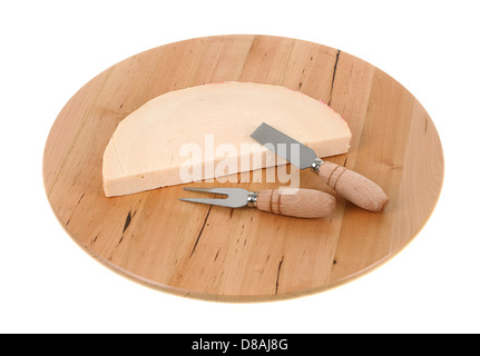 Italian spicy provolone cheese with cheese knife on white background Stock Photo